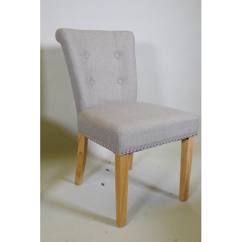 1041 - A pair of contemporary button back side chairs, raised on square tapering beechwood supports