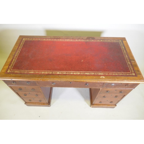 1043 - A Victorian mahogany nine drawer pedestal desk with gilt tooled leather inset top and ring pull hand... 