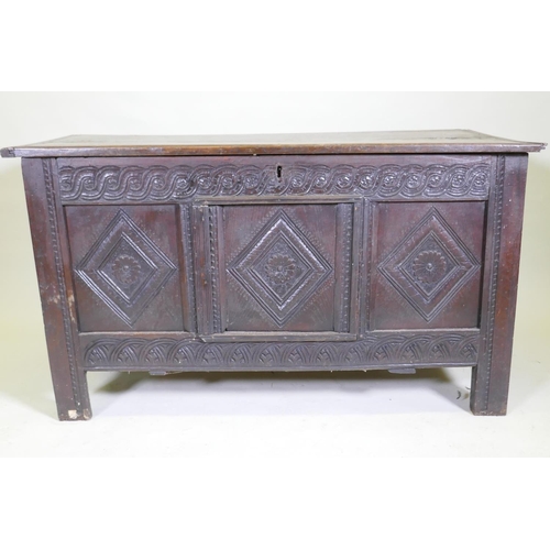 1047 - An C18th/C19th carved oak coffer with a plank top, adapted, 132 x 60cm high