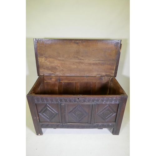 1047 - An C18th/C19th carved oak coffer with a plank top, adapted, 132 x 60cm high