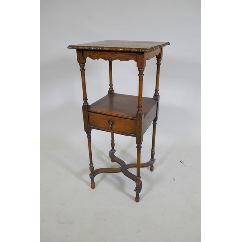 1049 - A Georgian style oak night stand with shaped top and single drawer to undertier, raised on turned su... 