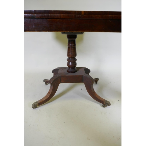 1052 - A Regency rosewood card table with Zebra wood crossbanded top, raised on a turned column with raised... 