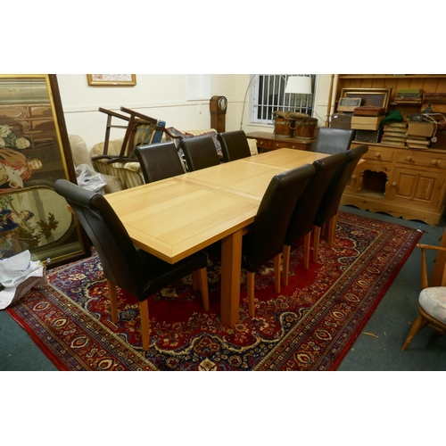 1055 - A contemporary golden oak dining table, with pull out ends, central fold out leaf, raised on removab... 