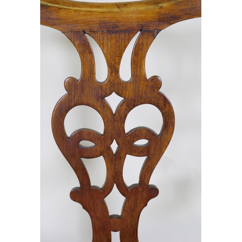 1057 - An C18th Chippendale style walnut chair with pierced splat back, raised on square supports and later... 