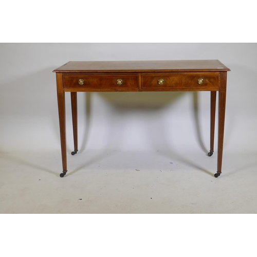 1060 - A C19th inlaid mahogany two drawer writing table with brass ring handles raised on square tapering s... 