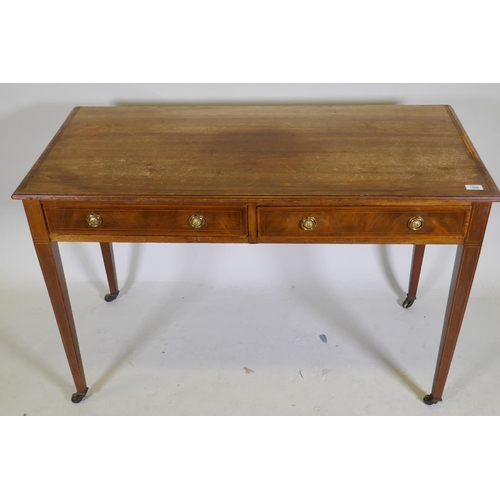 1060 - A C19th inlaid mahogany two drawer writing table with brass ring handles raised on square tapering s... 