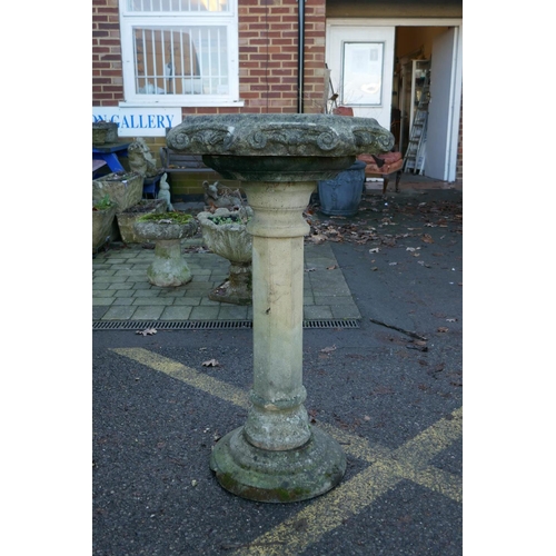 1062 - A reconstituted stone bird bath, 90cm high, 54cm diameter, AF