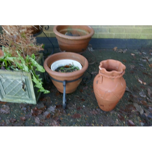 1064 - A quantity of terracotta, reconstituted stone and composition plant pots and planters, some with wro... 