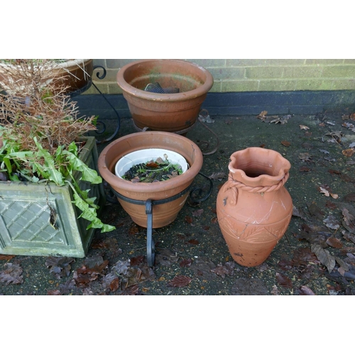 1064 - A quantity of terracotta, reconstituted stone and composition plant pots and planters, some with wro... 