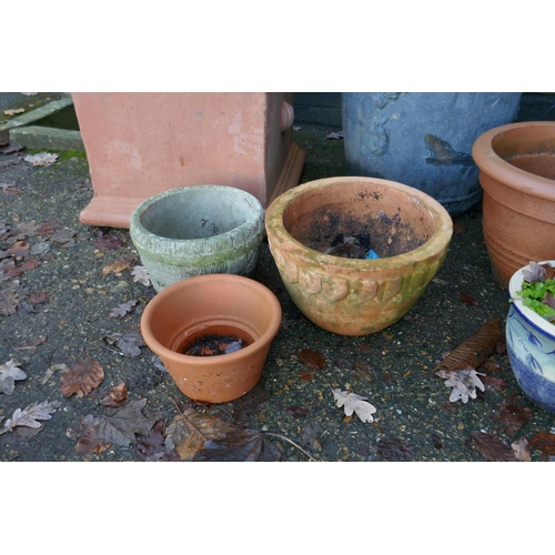 1064 - A quantity of terracotta, reconstituted stone and composition plant pots and planters, some with wro... 