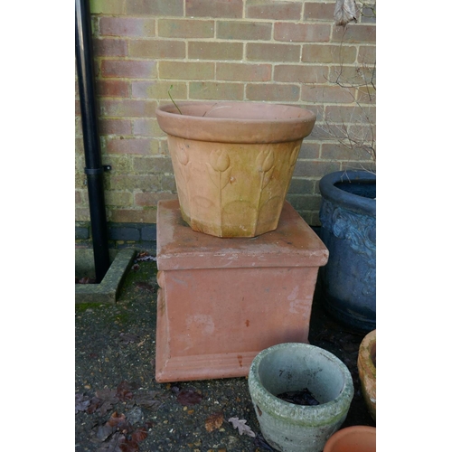 1064 - A quantity of terracotta, reconstituted stone and composition plant pots and planters, some with wro... 