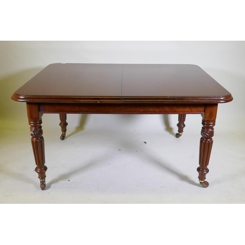 1068 - A Victorian mahogany wind-out dining table, moulded edge top and two extra leaves, raised on carved ... 