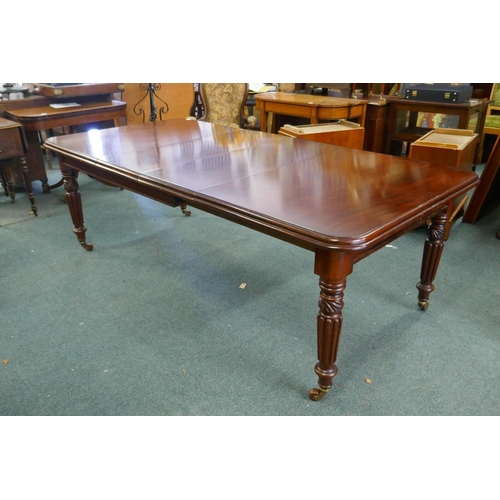 1068 - A Victorian mahogany wind-out dining table, moulded edge top and two extra leaves, raised on carved ... 