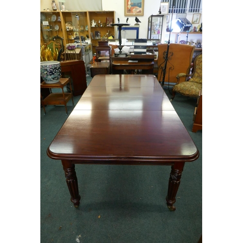 1068 - A Victorian mahogany wind-out dining table, moulded edge top and two extra leaves, raised on carved ... 