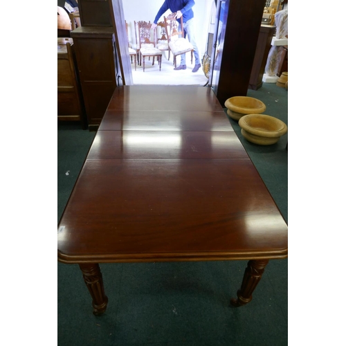 1068 - A Victorian mahogany wind-out dining table, moulded edge top and two extra leaves, raised on carved ... 