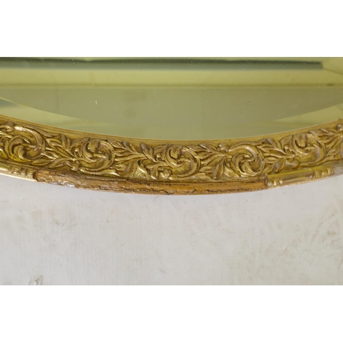 1070 - A gilt composition oval wall mirror, 59 x 86cm