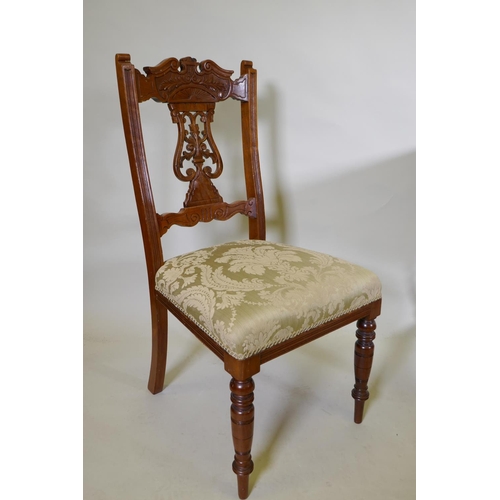 1072 - A set of six Edwardian oak dining chairs with carved and pierced lyre backs, turned supports and sab... 