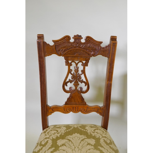 1072 - A set of six Edwardian oak dining chairs with carved and pierced lyre backs, turned supports and sab... 