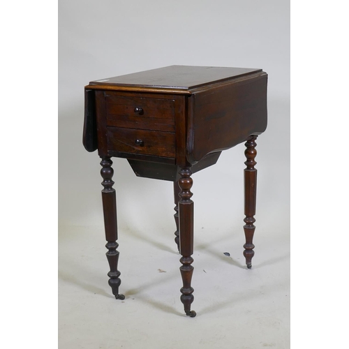 1073 - A William IV rosewood workbox, with shaped drop flaps, two drawers and pull out well, raised on turn... 