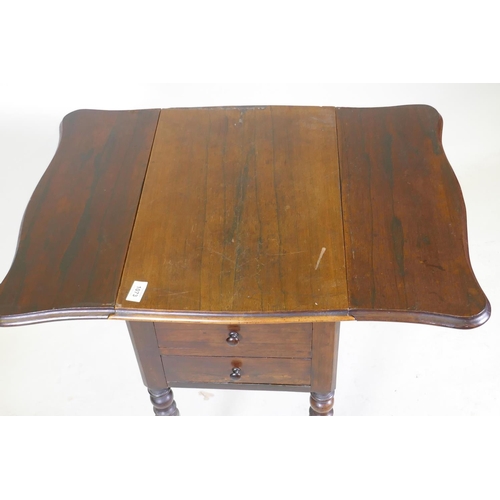 1073 - A William IV rosewood workbox, with shaped drop flaps, two drawers and pull out well, raised on turn... 