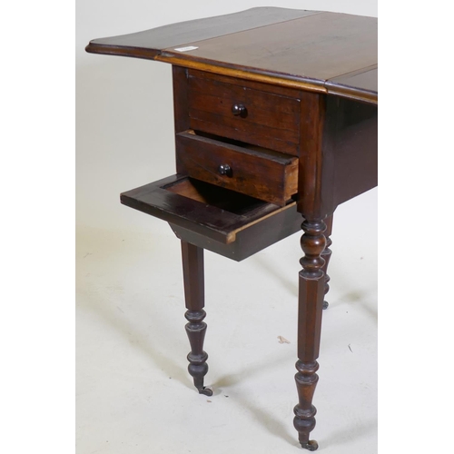 1073 - A William IV rosewood workbox, with shaped drop flaps, two drawers and pull out well, raised on turn... 