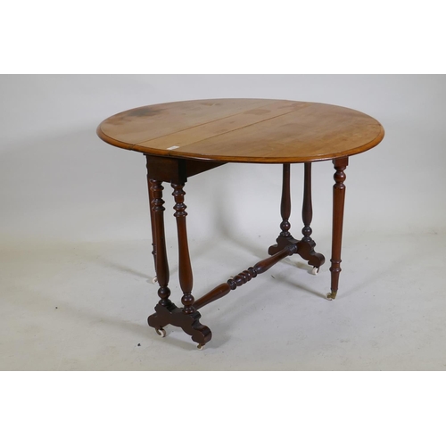 1074 - A Victorian walnut Sutherland table with turned supports and centre stretcher, 104 x 89 x 70cm