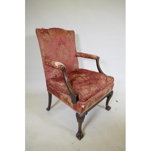 1077 - A late C19th Gainsborough chair with hump back, scroll arms, carved cabriole legs and ball and claw ... 