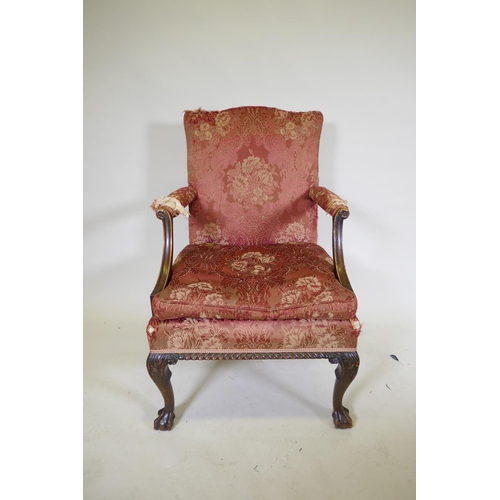 1077 - A late C19th Gainsborough chair with hump back, scroll arms, carved cabriole legs and ball and claw ... 