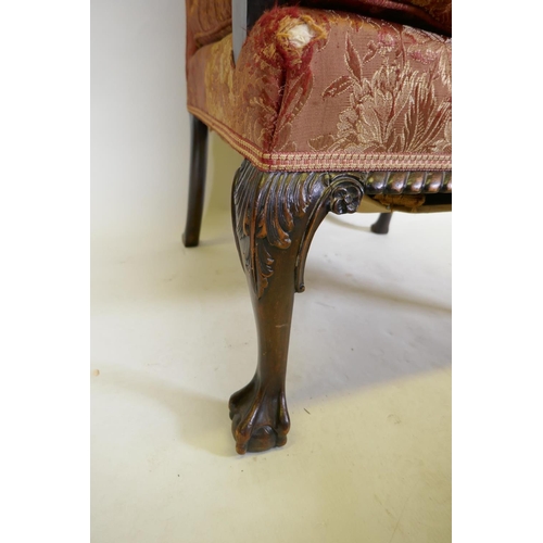 1077 - A late C19th Gainsborough chair with hump back, scroll arms, carved cabriole legs and ball and claw ... 