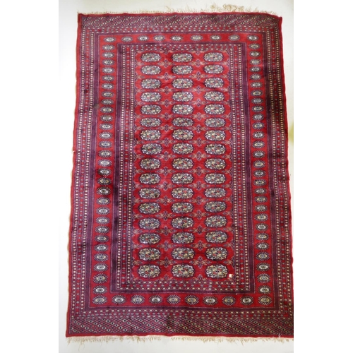 1078 - A fine woven red ground wool Bokharra rug, AF, 128 x 190cm