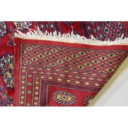 1078 - A fine woven red ground wool Bokharra rug, AF, 128 x 190cm