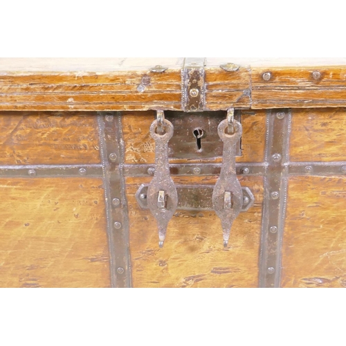 1079 - An antique Indian teak coffer with iron strapwork, carrying handles and hasps, 121 x 64 x 66cm