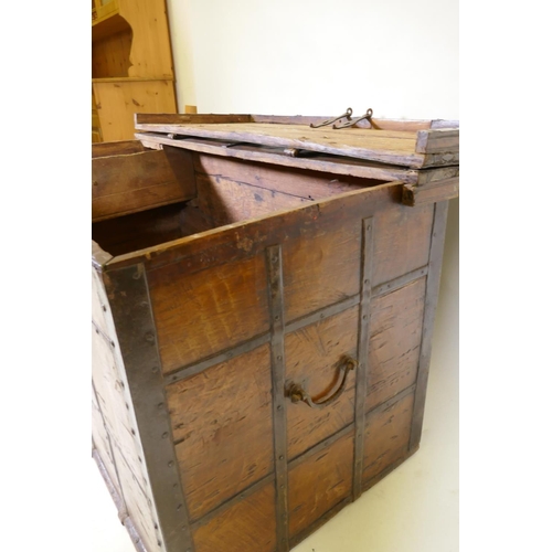 1079 - An antique Indian teak coffer with iron strapwork, carrying handles and hasps, 121 x 64 x 66cm