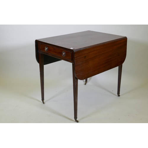 1088 - A Georgian mahogany pembroke table with single end drawer, raised on square tapering supports with b... 