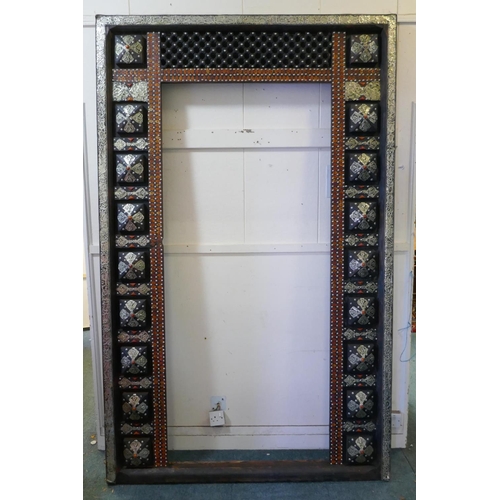 1089 - A large oriental door in frame with white metal decorative mounts and inset with amber style shards,... 