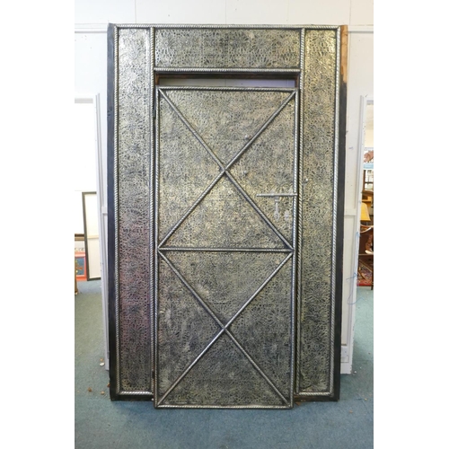 1089 - A large oriental door in frame with white metal decorative mounts and inset with amber style shards,... 