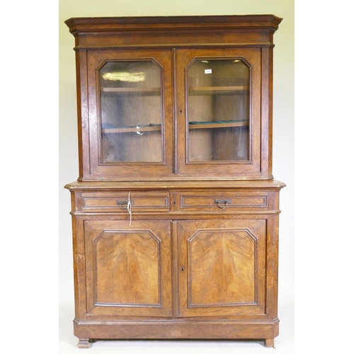 1090 - A C19th continental walnut bookcase, the upper section with two shaped glazed doors, the base with t... 