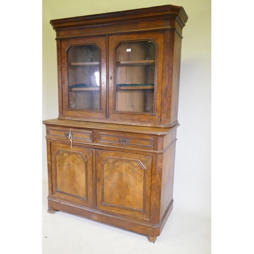 1090 - A C19th continental walnut bookcase, the upper section with two shaped glazed doors, the base with t... 