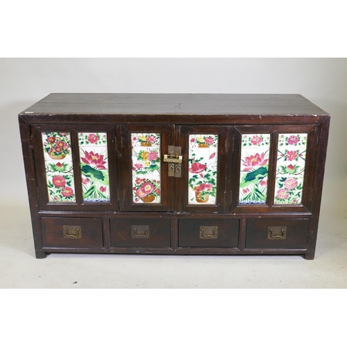 1093 - An antique Chinese stained elm side cabinet with two cupboards fitted with folding doors, inset with... 