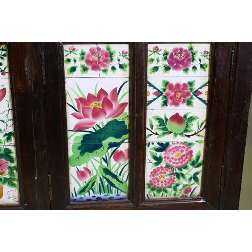 1093 - An antique Chinese stained elm side cabinet with two cupboards fitted with folding doors, inset with... 