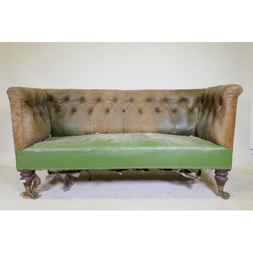 1094 - A C19th settee, with buttoned back leather back and arms, raised on mahogany turned tulip shaped sup... 