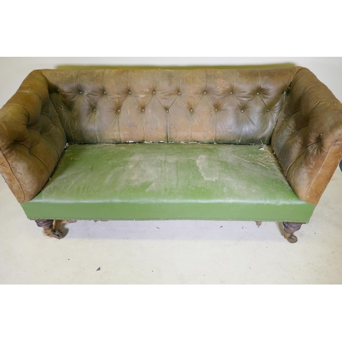 1094 - A C19th settee, with buttoned back leather back and arms, raised on mahogany turned tulip shaped sup... 