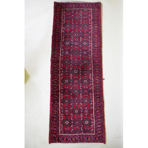 1095 - A Persian red ground full pile wool runner with an allover geometric design, 195 x 70cm