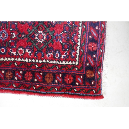 1095 - A Persian red ground full pile wool runner with an allover geometric design, 195 x 70cm