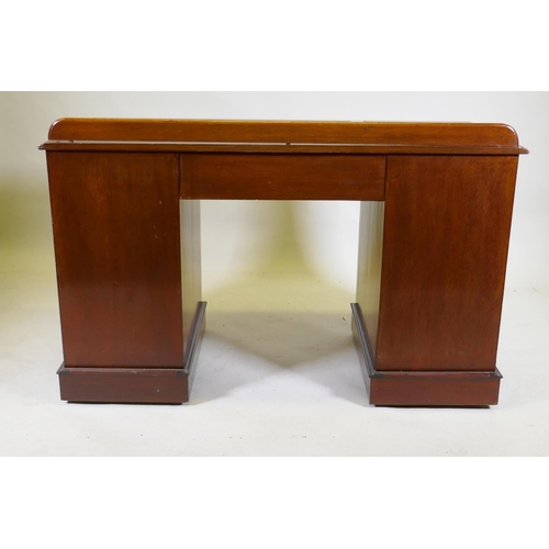 1097 - A C19th mahogany nine drawer kneehole desk with original locks and turned wood handles, raised on a ... 