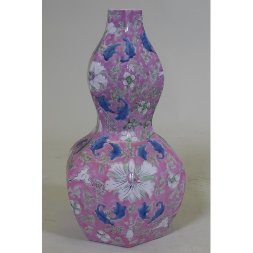 110 - A Chinese double gourd shaped porcelain table lamp with lotus flower decoration and pink glaze, lack... 