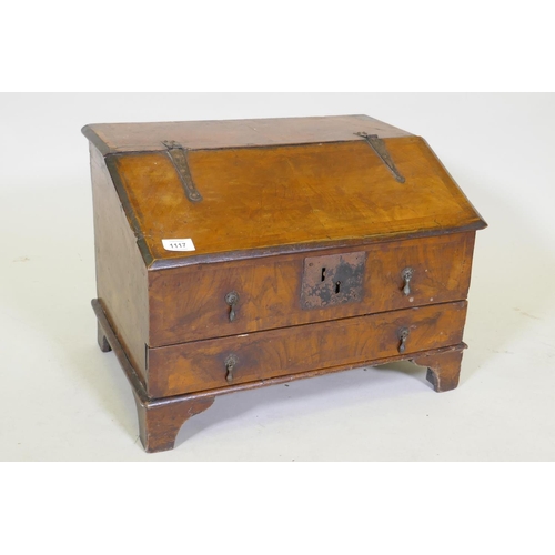 1107 - An early C18th walnut bible box with fall front and single drawer, raised on bracket supports, adapt... 