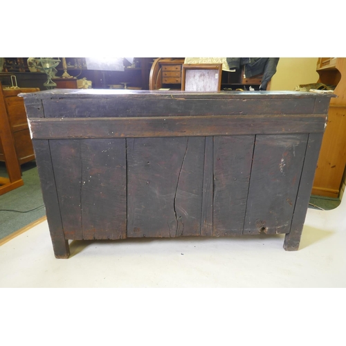 1108 - An C18th continental bog oak dresser/buffet with three cupboards and fielded carved panels with Gree... 