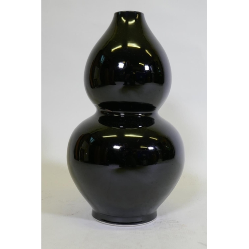 111 - A double gourd shaped black glazed ceramic vase, initialled P.P. to base, and drilled, 41cm high