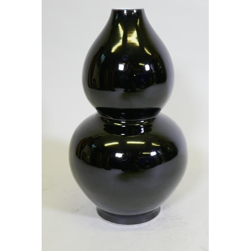 111 - A double gourd shaped black glazed ceramic vase, initialled P.P. to base, and drilled, 41cm high